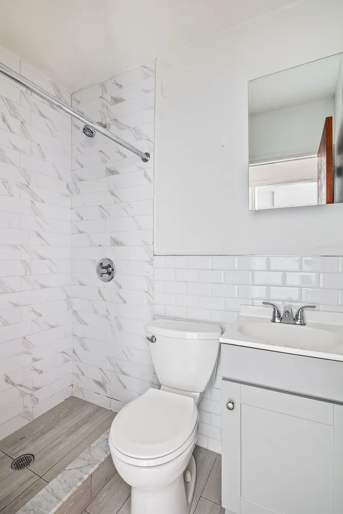 a bathroom with a toilet a sink and a shower