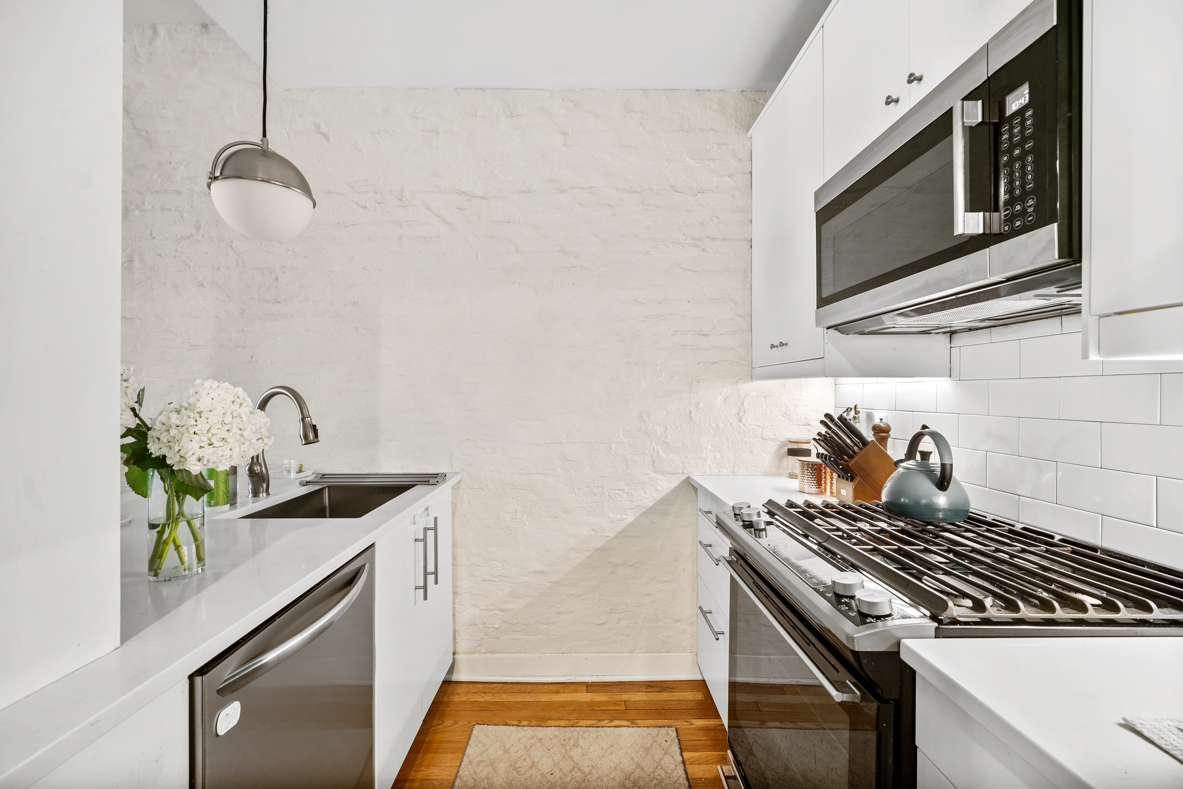 353 12th Street, Unit 2 Brooklyn, NY 11215 - Photo 2 of 17 a kitchen with stainless steel appliances granite countertop a sink stove and microwave