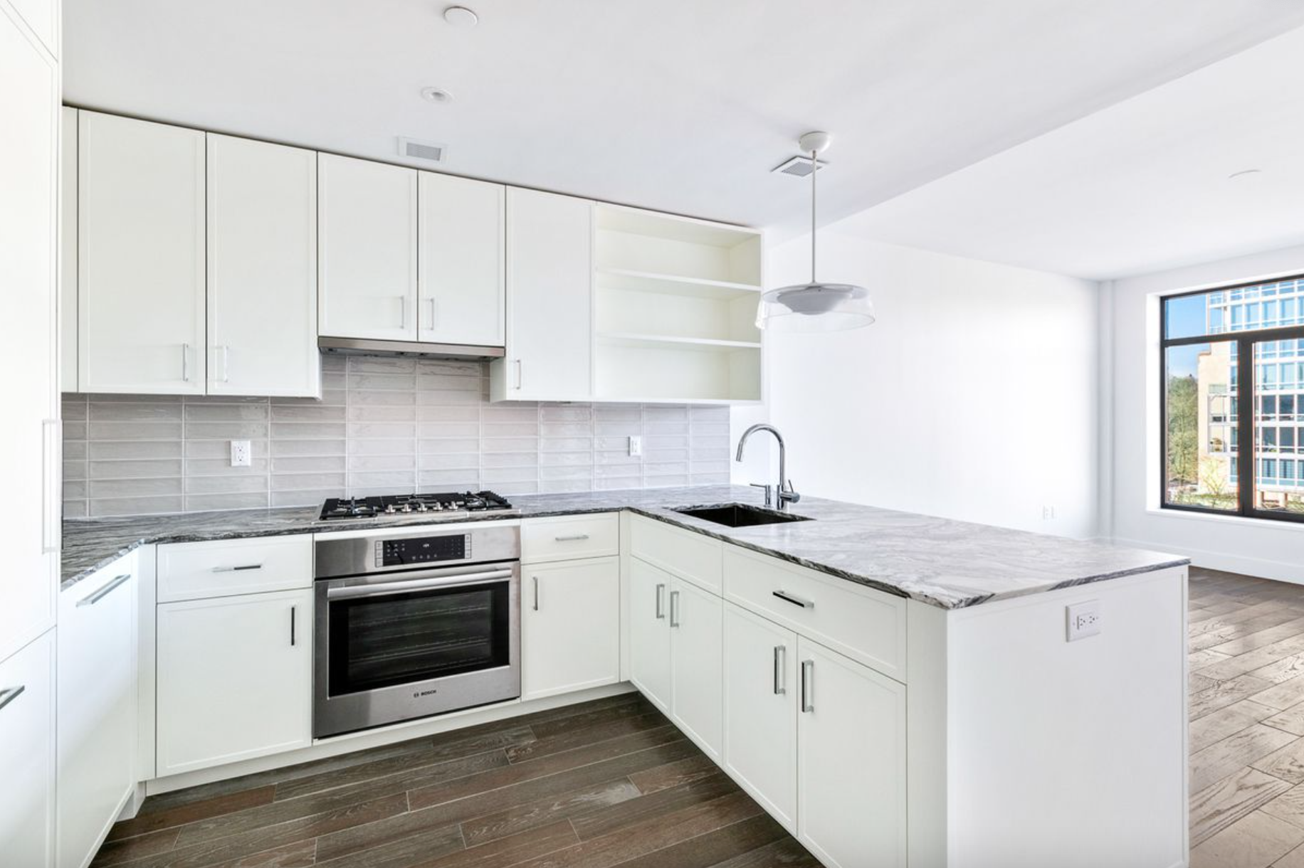 10 Lenox Avenue, Unit 5D Manhattan, NY 10026 - Photo 2 of 13 a kitchen with granite countertop white cabinets and white appliances