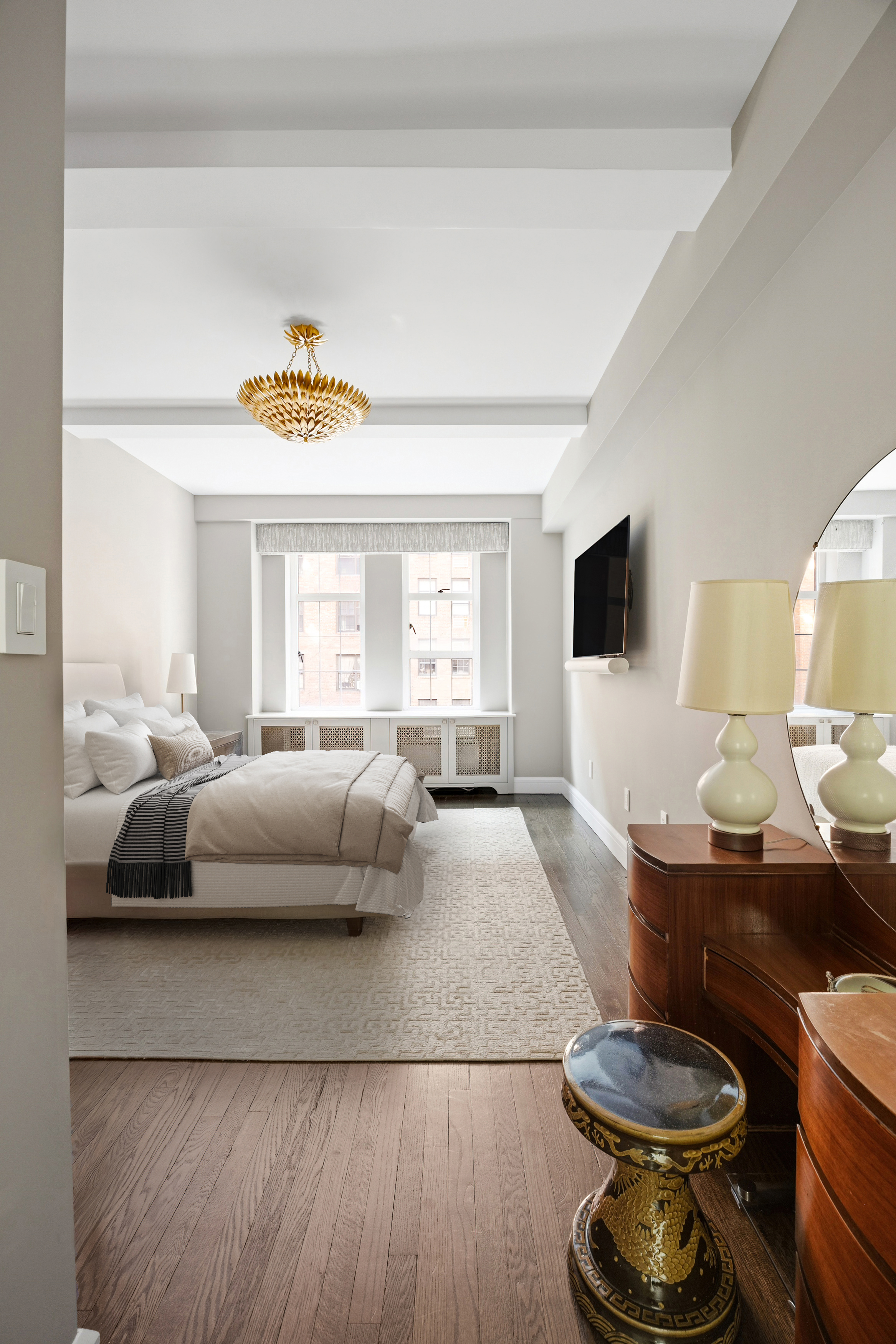 470 West 24th Street, Unit 9J Manhattan, NY 10011 - Photo 8 of 13 a living room with furniture and a flat screen tv