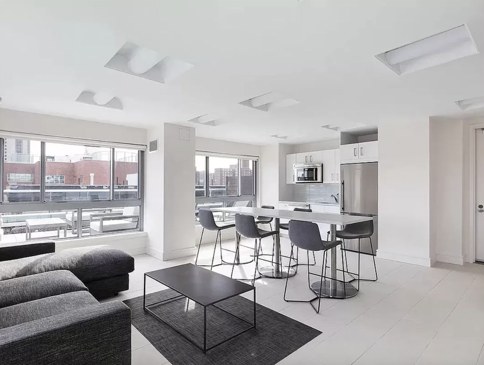 171 West 131st Street, Unit PH4 Manhattan, NY 10027 - Photo 6 of 10 a living room with furniture and a large window