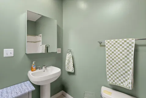 a bedroom with a large bed a rug and a window