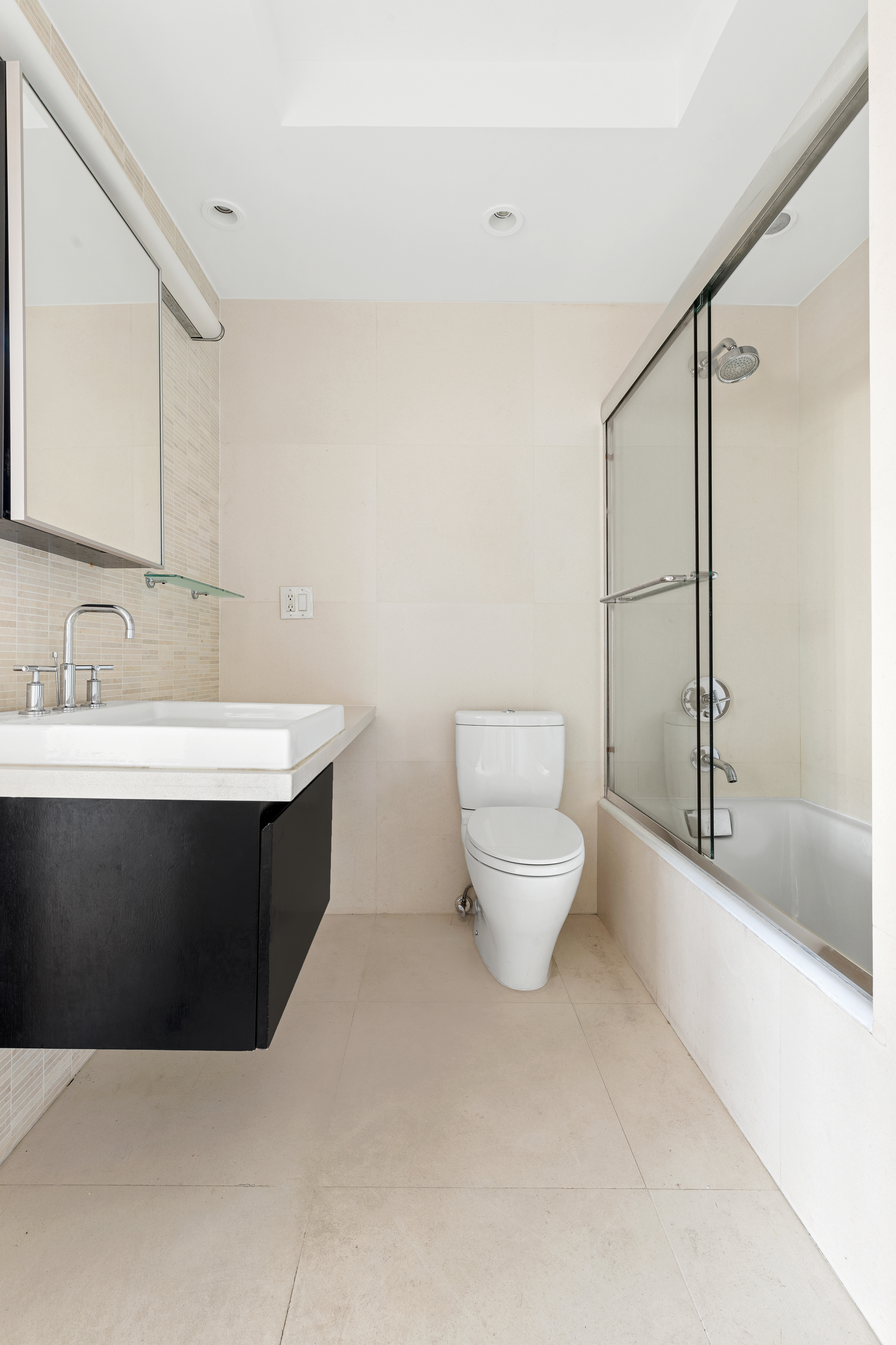 140 Charles Street, Unit 7A Manhattan, NY 10014 - Photo 6 of 8 a bathroom with a sink a toilet and shower