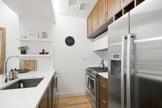 42 Maspeth Avenue, Unit 1D Brooklyn, NY 11211 - Photo 4 of 28 a kitchen with stainless steel appliances granite countertop a refrigerator and a sink
