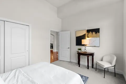 a bedroom with a bed and a chair