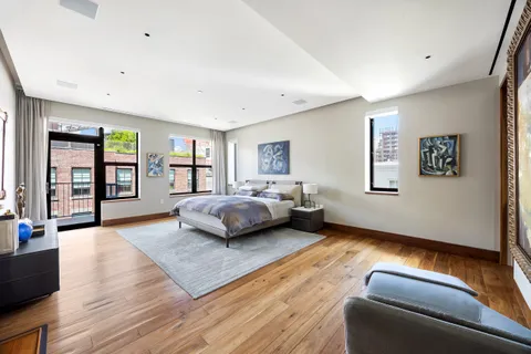 a bedroom with a bed couch and a window