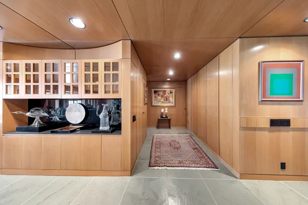 a hall with wooden floor and a sink