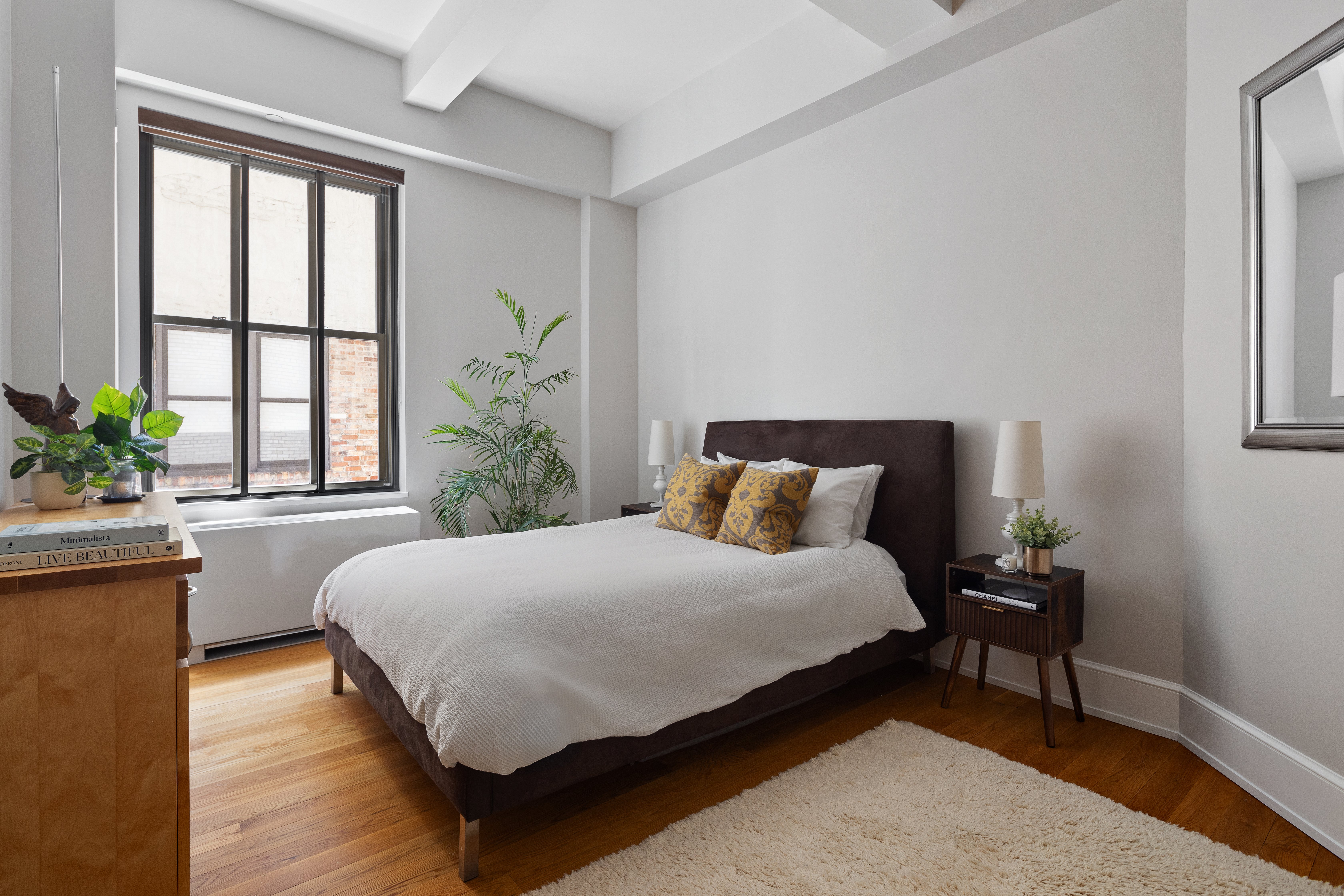 130 West 30th Street, Unit 3B Manhattan, NY 10001 - Photo 10 of 15 a bedroom with a large bed and a potted plant
