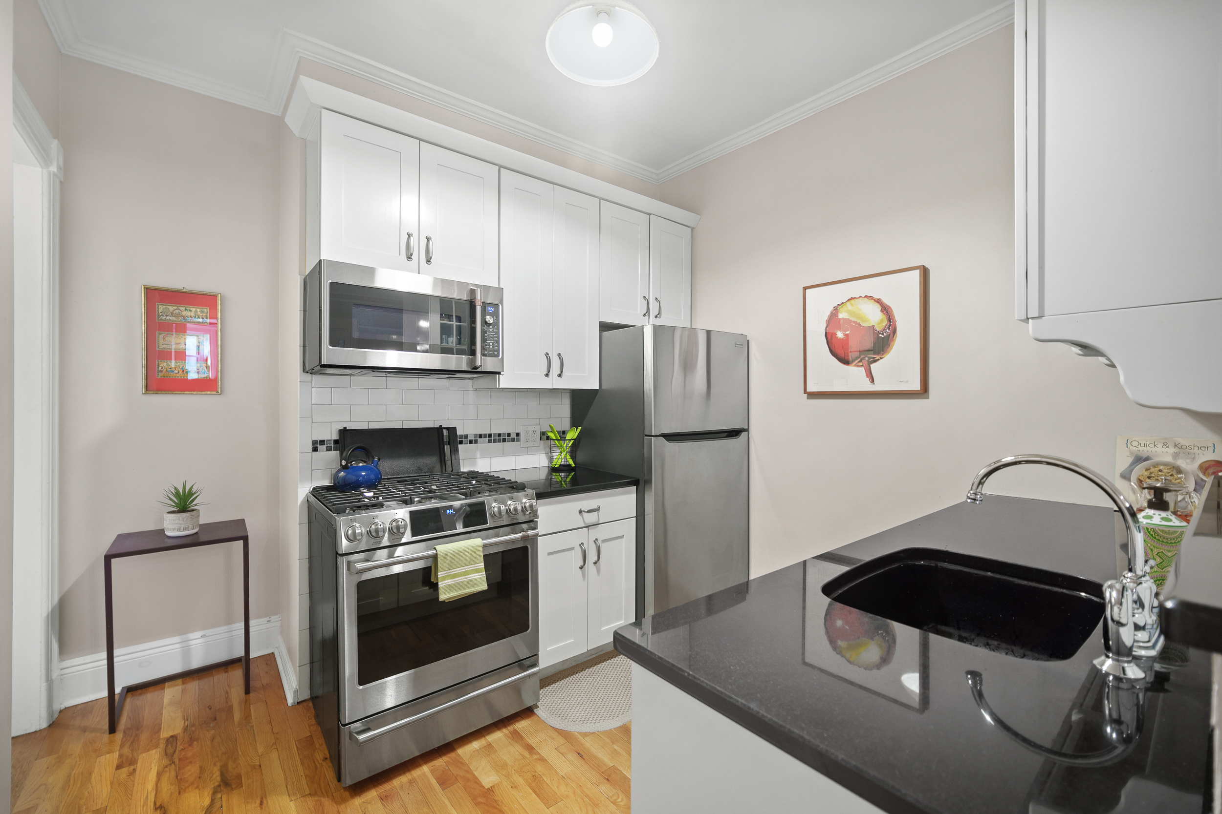 182 Saint Marks Avenue, Unit 2 Brooklyn, NY 11238 - Photo 6 of 14 a kitchen with stainless steel appliances a stove a microwave and a refrigerator