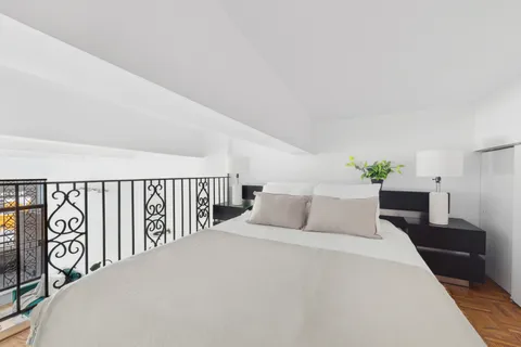 a bedroom with a large bed and a tv