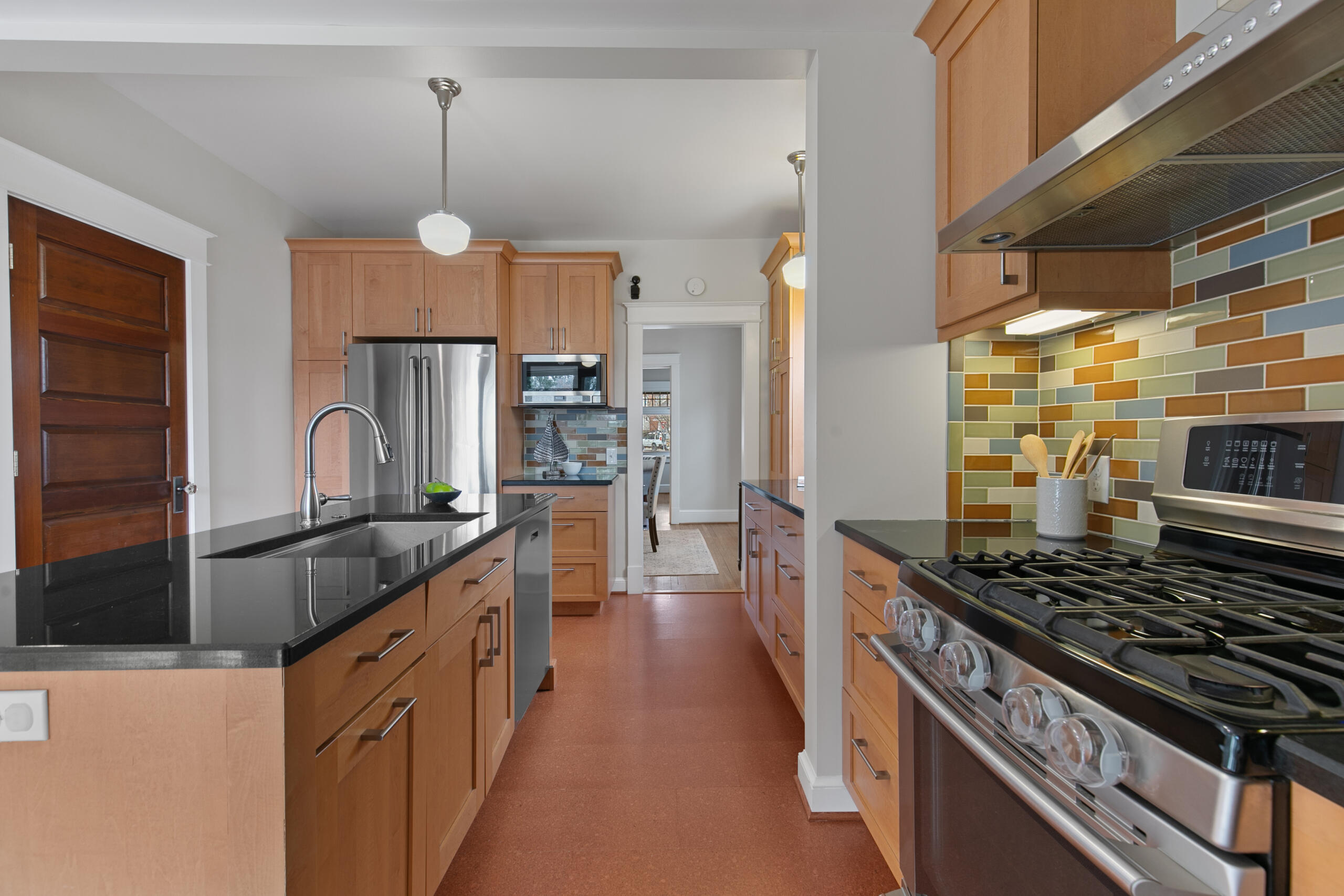 1908 Glen Ross Road Silver Spring, MD 20910 - Photo 17 of 63 a kitchen with kitchen island granite countertop a sink stove and refrigerator