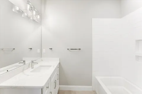 a bathroom with a sink a mirror and a bathtub