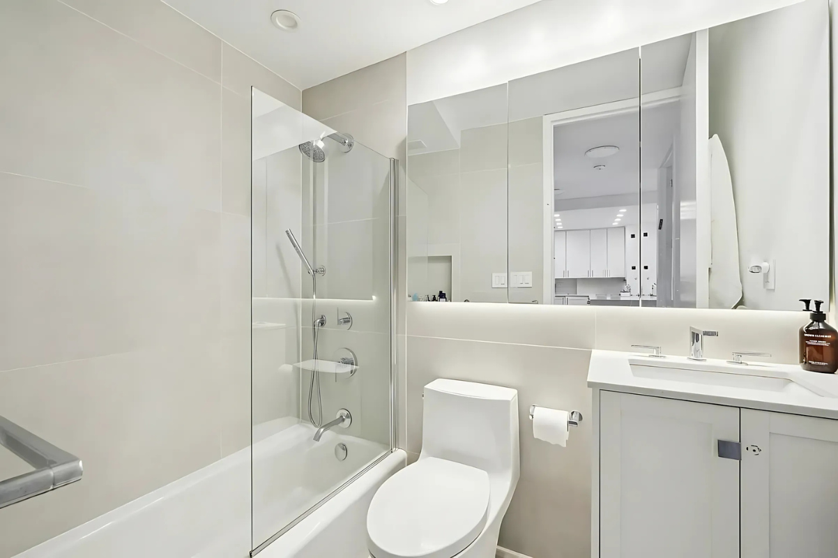 215 West 95th Street, Unit 9J Manhattan, NY 10025 - Photo 5 of 11 a bathroom with a sink toilet and shower