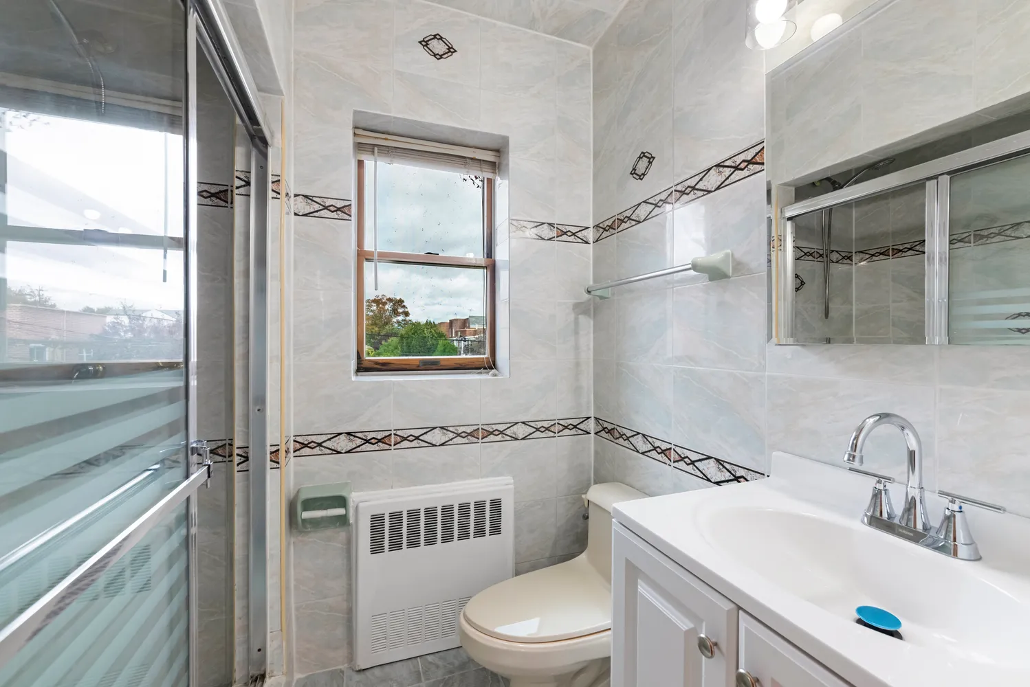 a bathroom with a sink toilet and shower