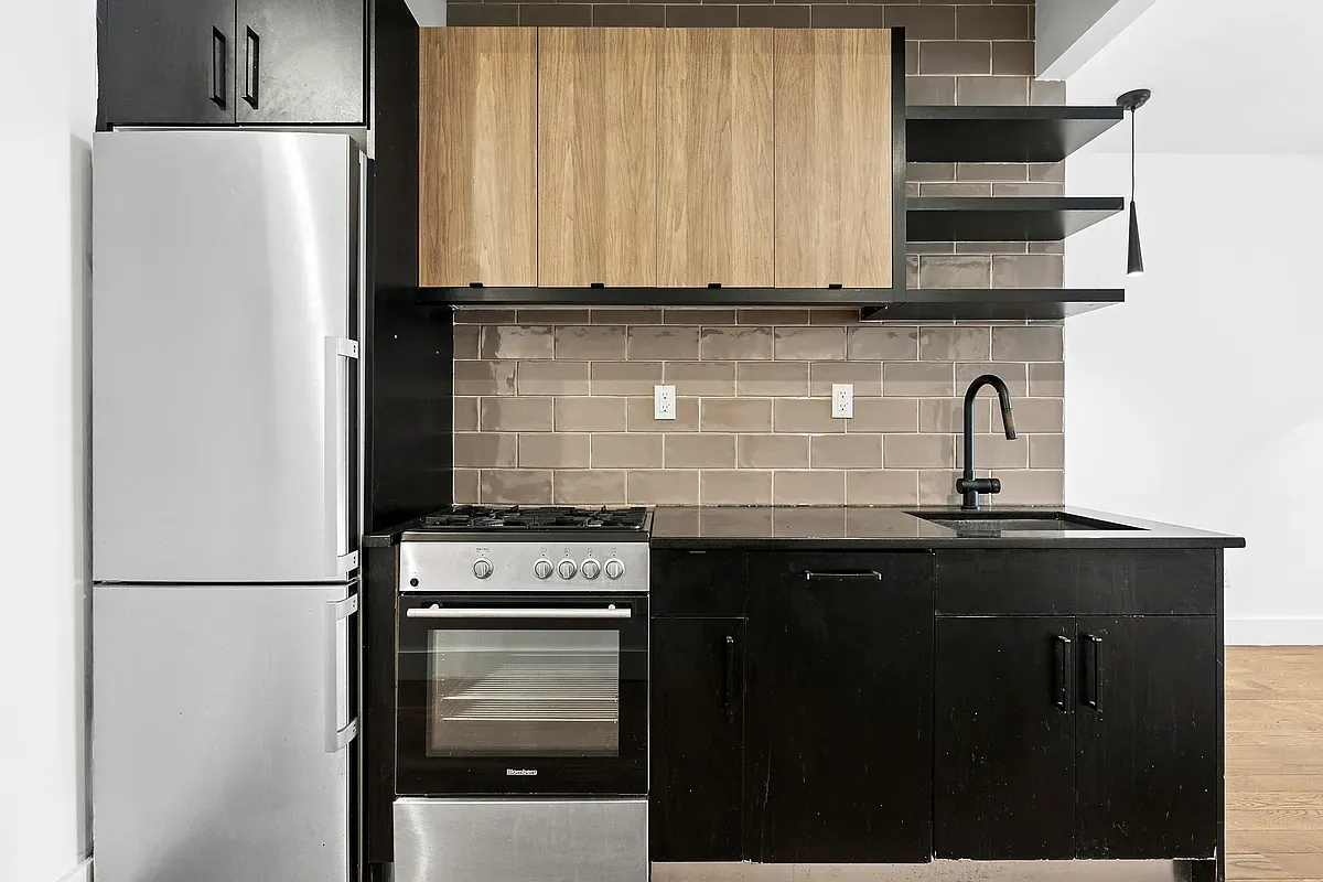 a kitchen with a sink a stove and refrigerator
