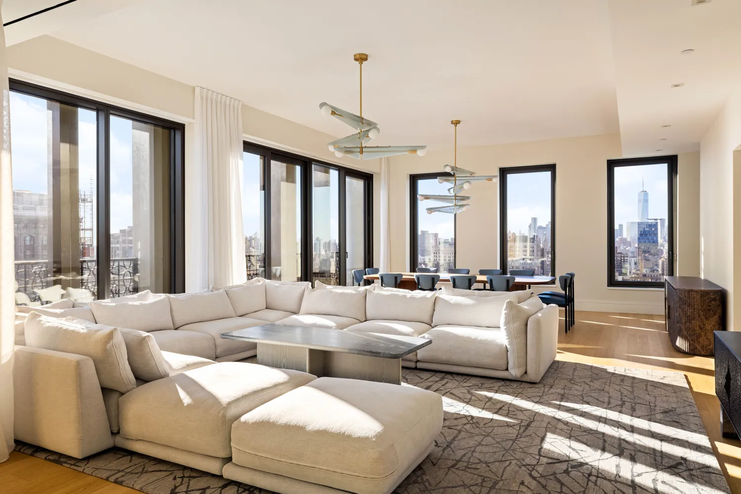 a living room with furniture and large windows