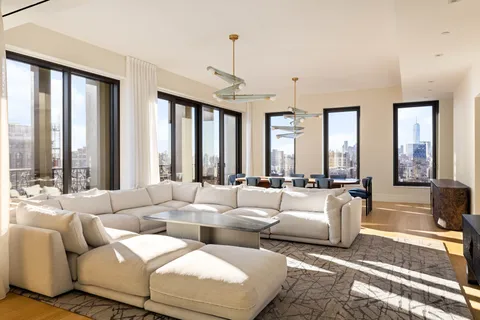 a living room with furniture and large windows