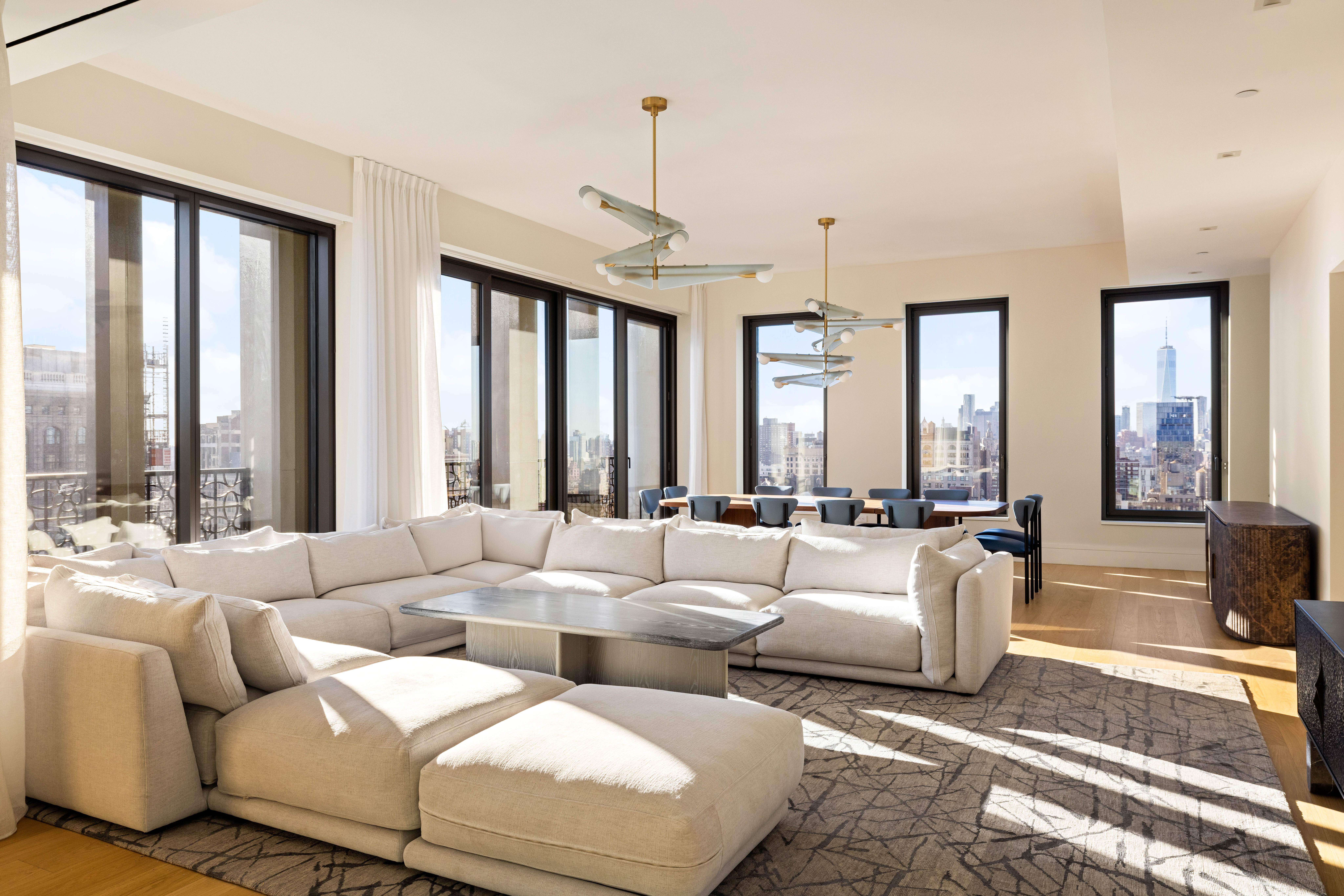 a living room with furniture and large windows