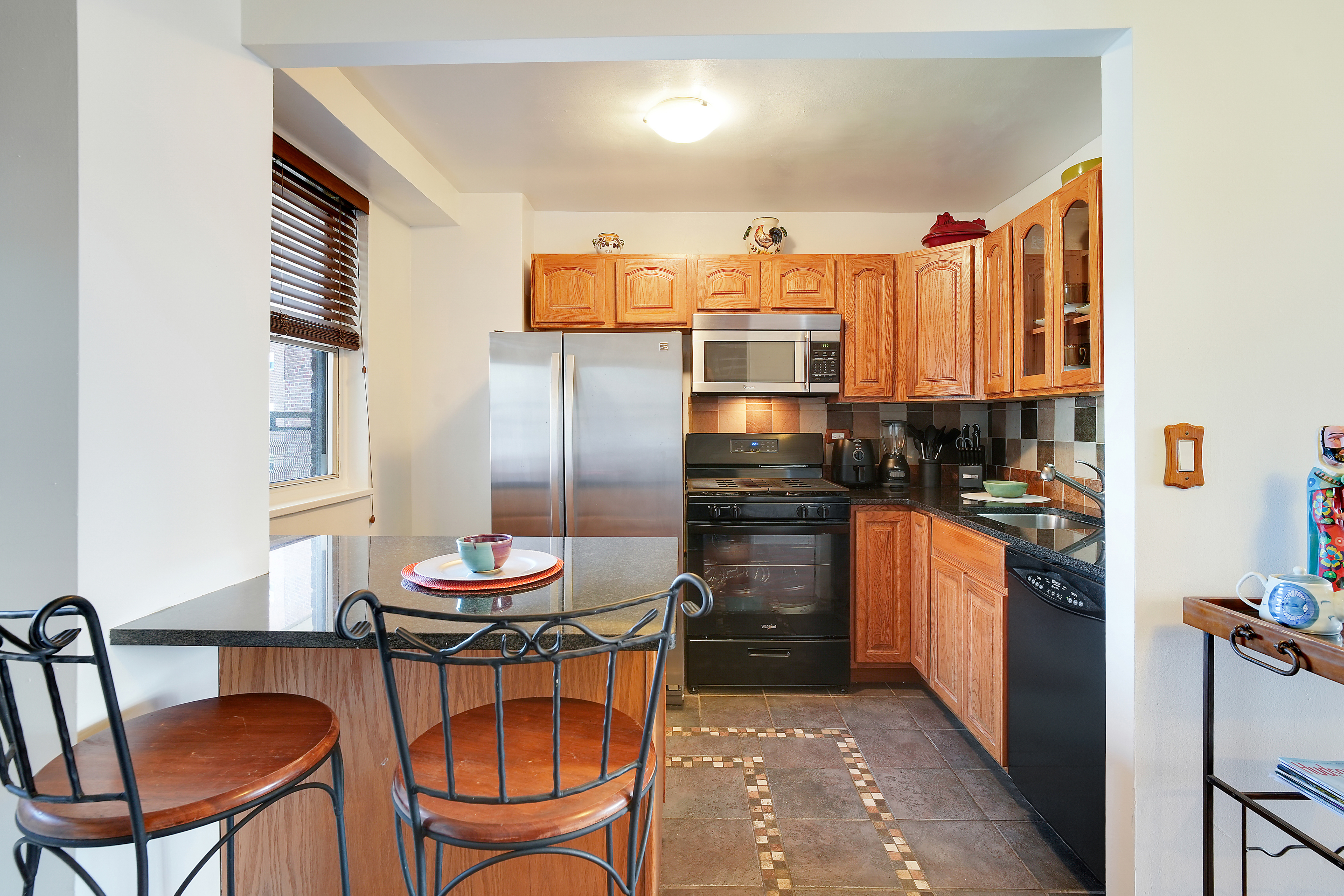 5700 Arlington Avenue, Unit 16T Bronx, NY 10471 - Photo 5 of 16 a kitchen with stainless steel appliances granite countertop a refrigerator and a stove top oven