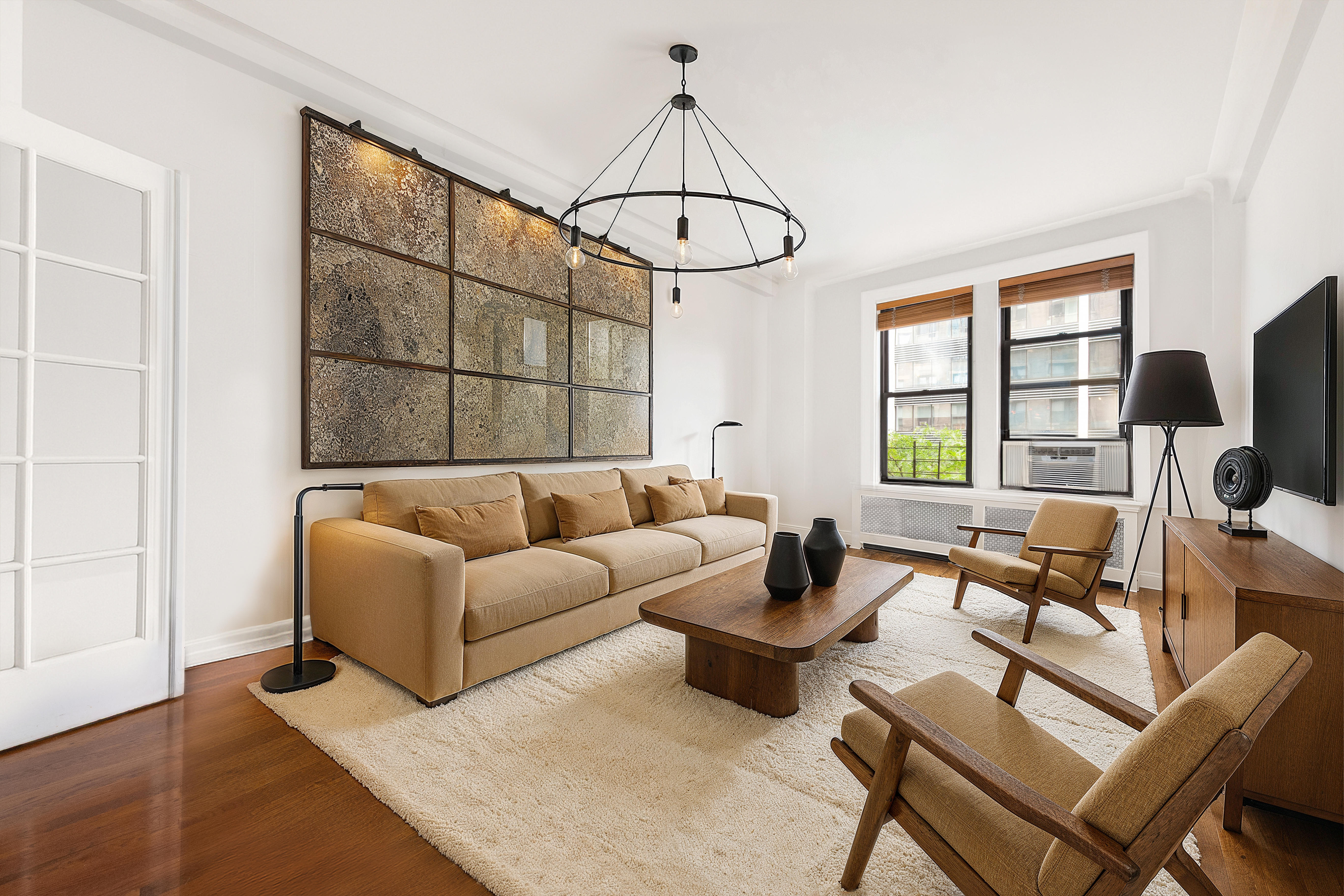 a living room with furniture a dining table and a window
