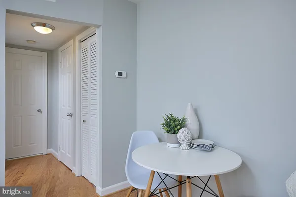 a dining room with furniture and wooden floor
