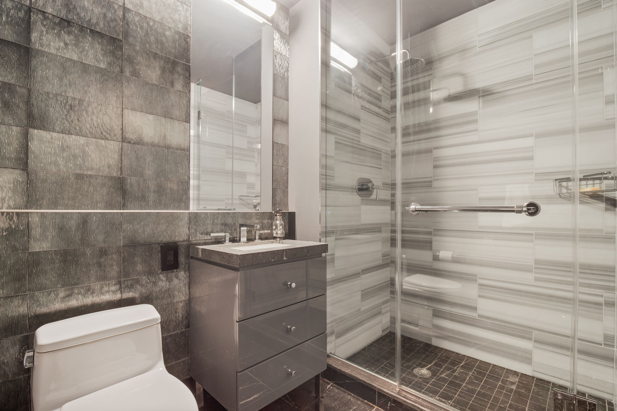 460 West 42nd Street, Unit 55F Manhattan, NY 10036 - Photo 7 of 9 a bathroom with a toilet and a shower