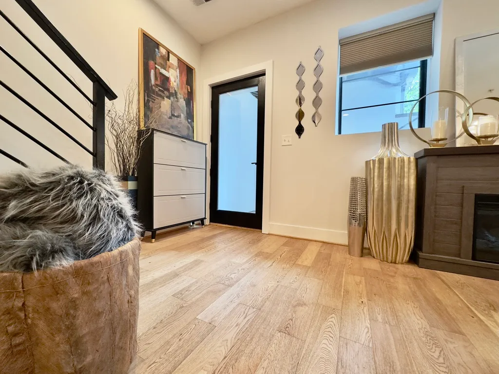 a view of a room with wooden floor and a hallway