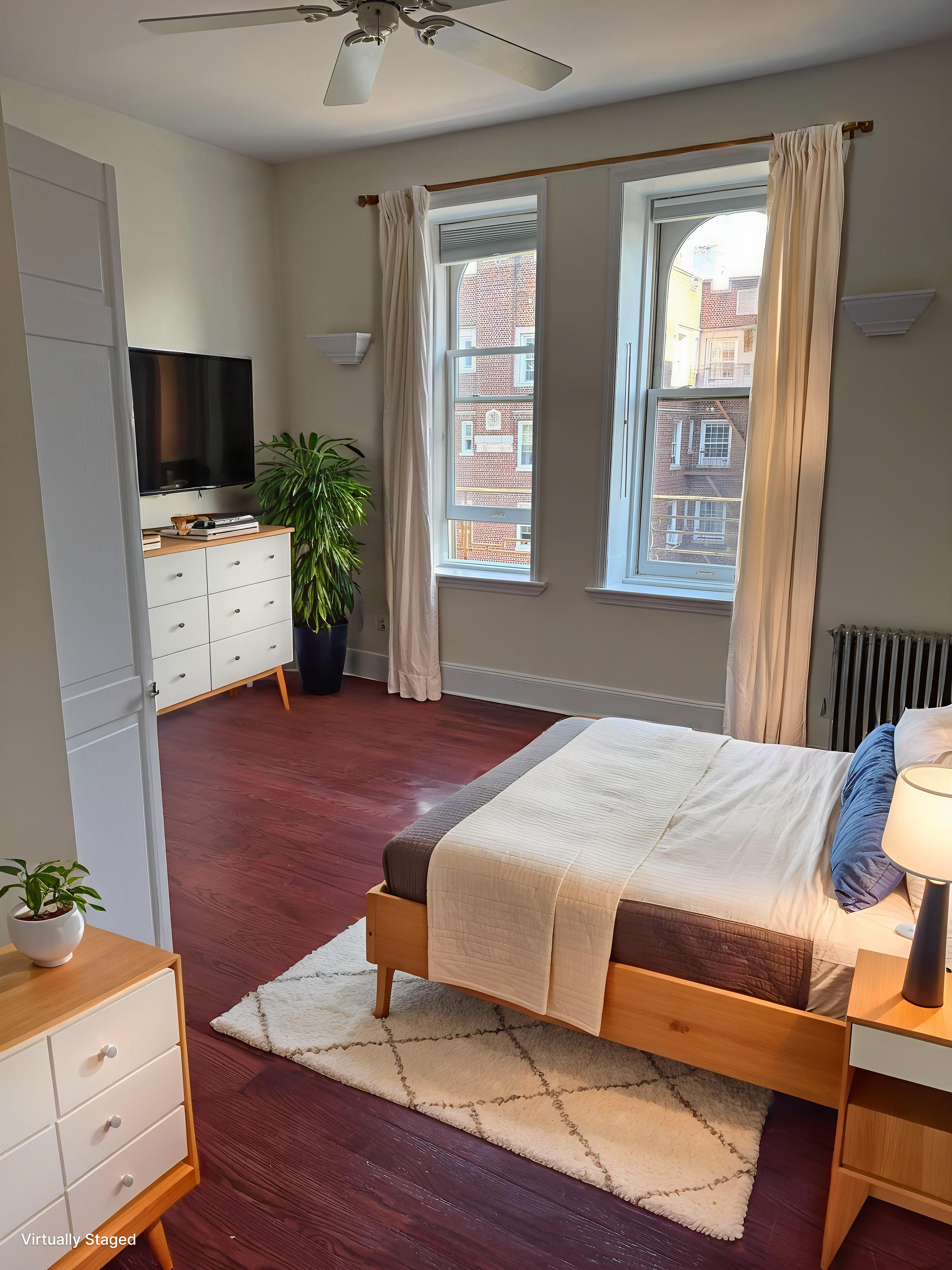 260 Cumberland Street, Unit 21 Brooklyn, NY 11205 - Photo 7 of 13 a bedroom with a bed and a flat screen tv