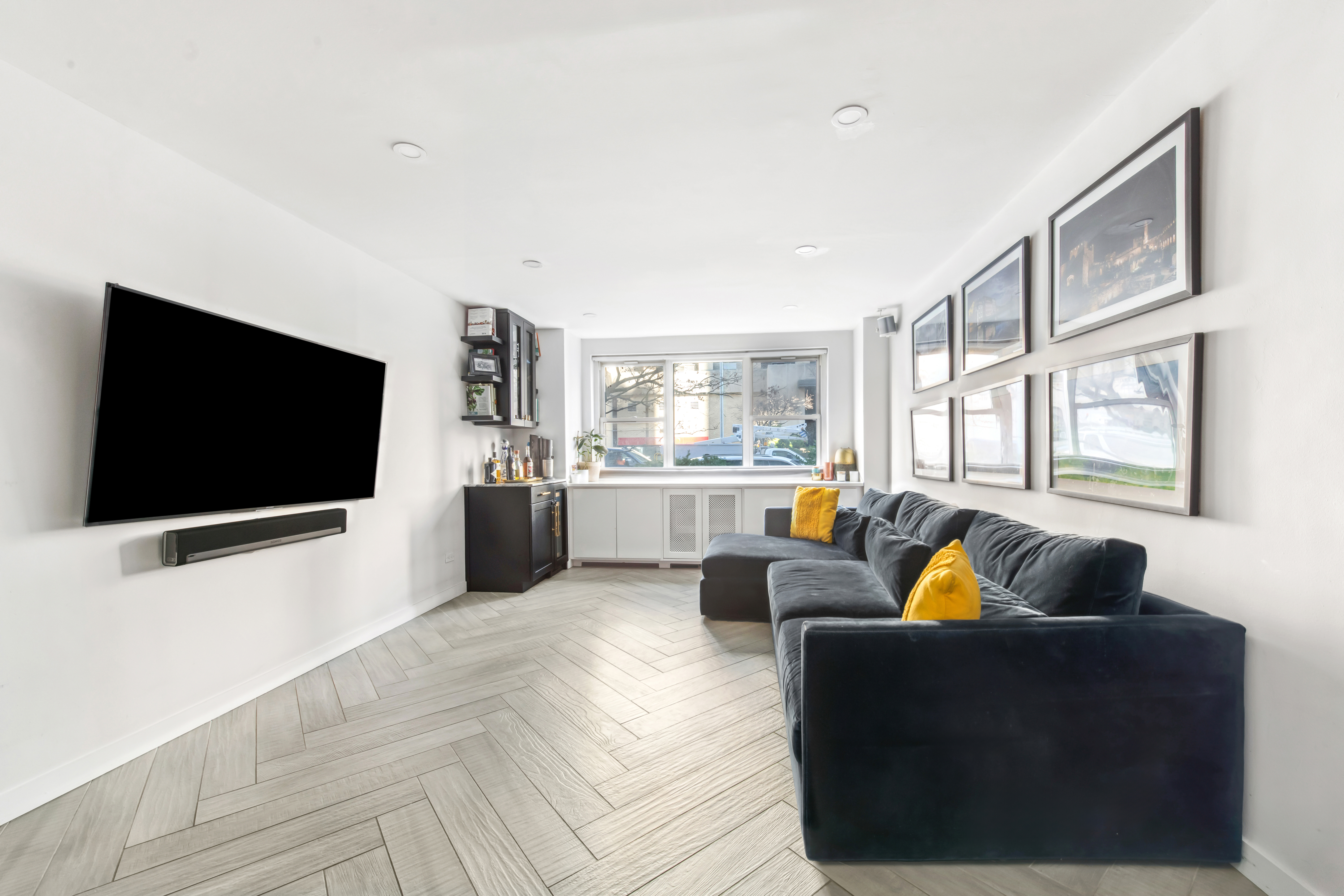 340 East 80th Street, Unit 1D Manhattan, NY 10075 - Photo 4 of 15 a living room with furniture and a flat screen tv