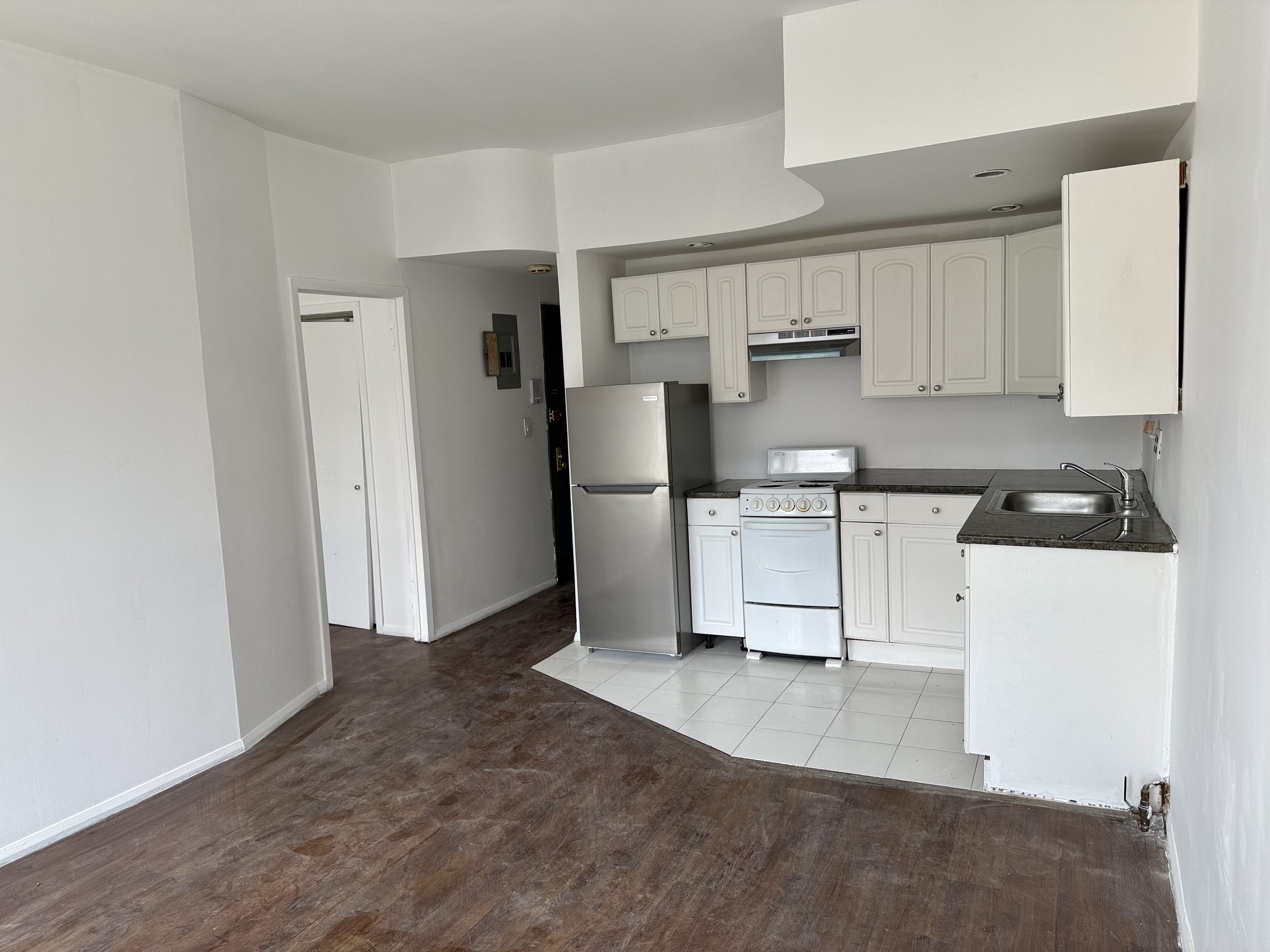 a kitchen with stainless steel appliances a refrigerator sink and cabinets