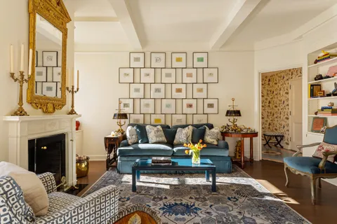 a living room with furniture a fireplace and a window