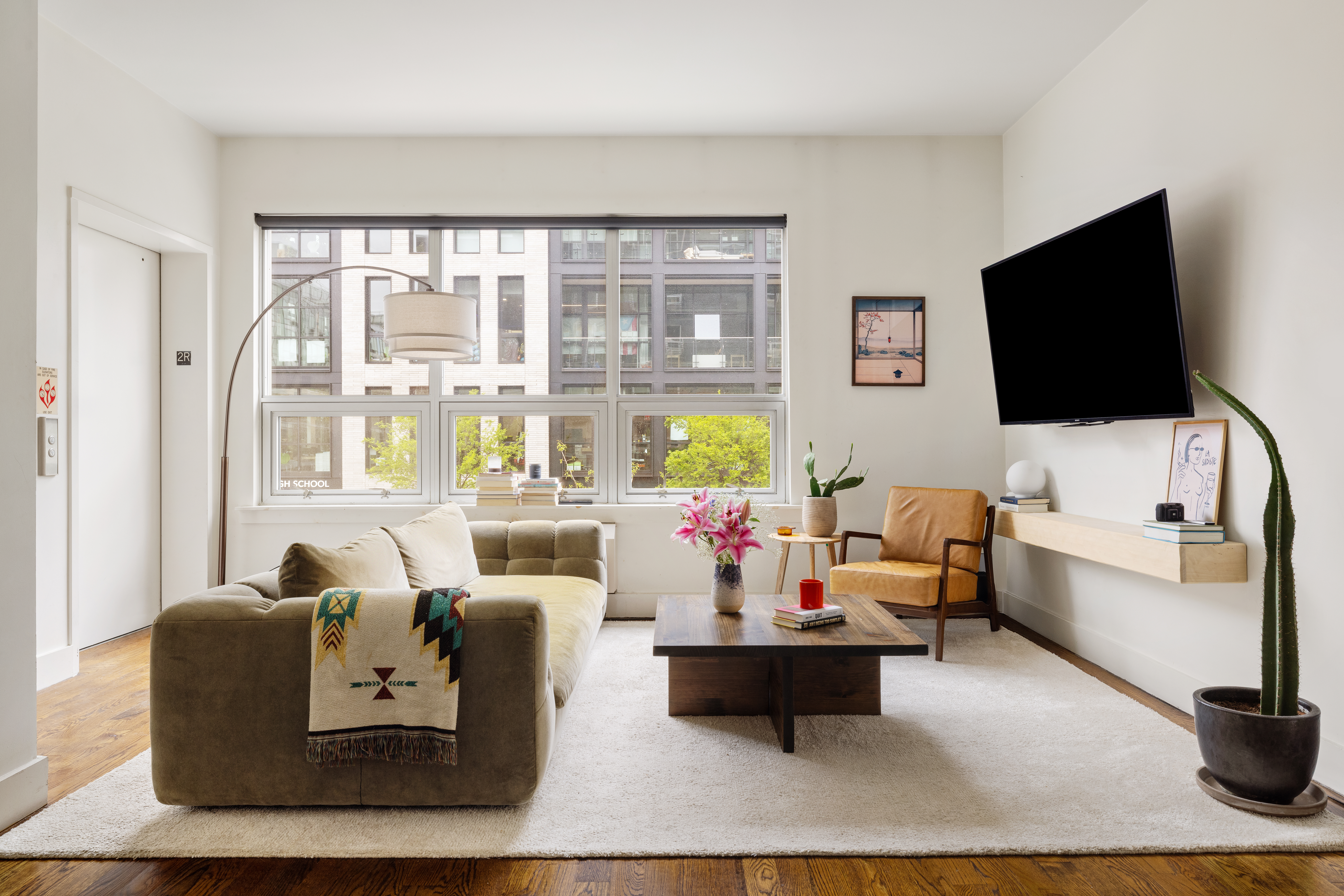 a living room with furniture and a flat screen tv