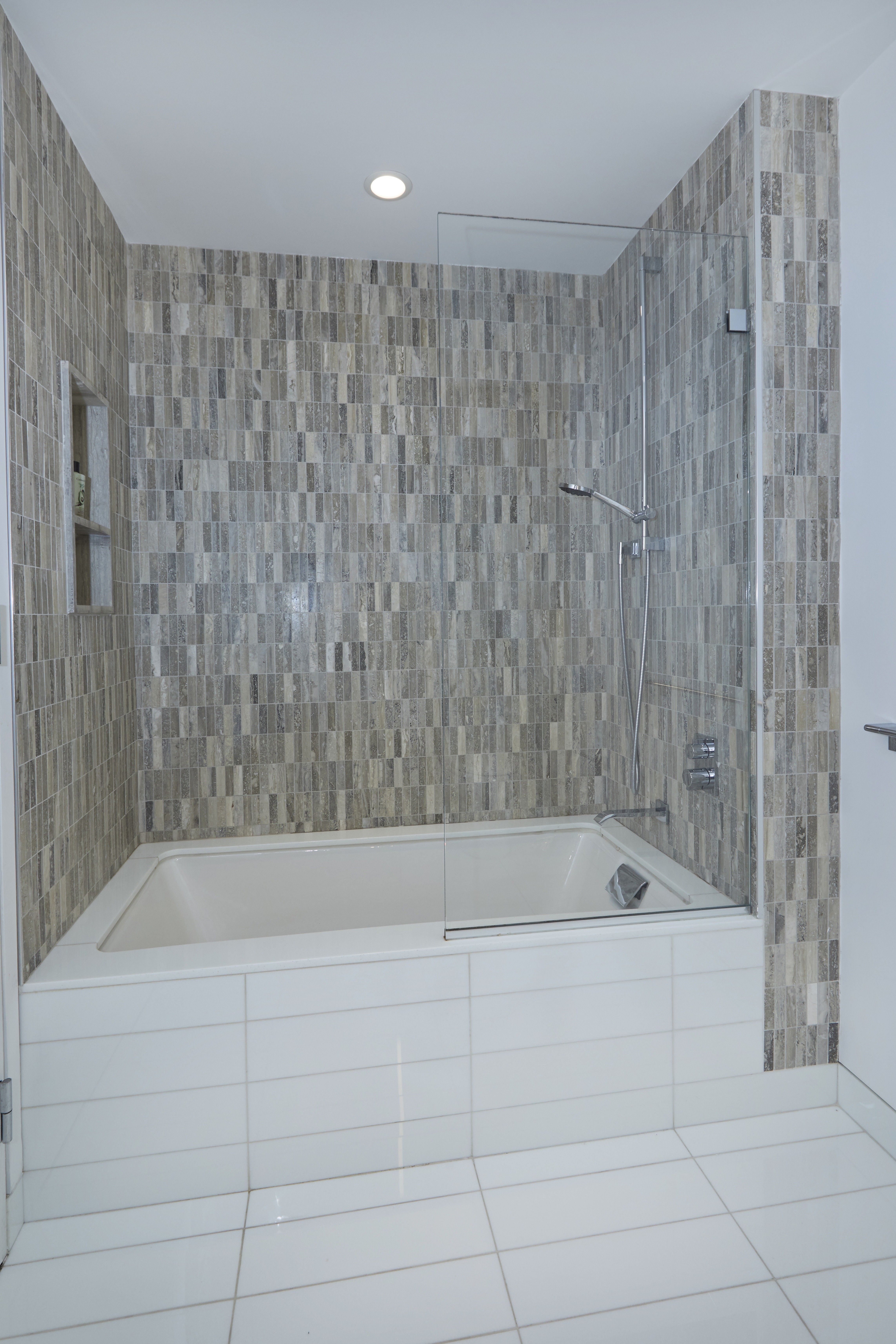 70 Charlton Street, Unit 7E Manhattan, NY 10014 - Photo 7 of 17 a bathroom with a bathtub and a shower
