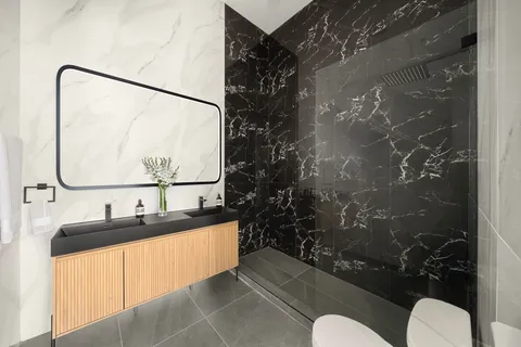 a bathroom with a sink mirror vanity and toilet