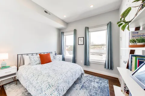 a bedroom with furniture and a rug