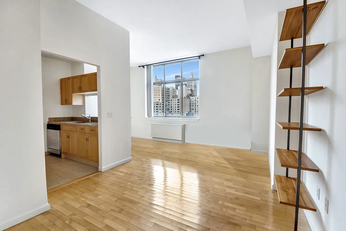 250 East 30th Street, Unit 10H Manhattan, NY 10016 - Photo 7 of 9 a view of empty room with kitchen and windows