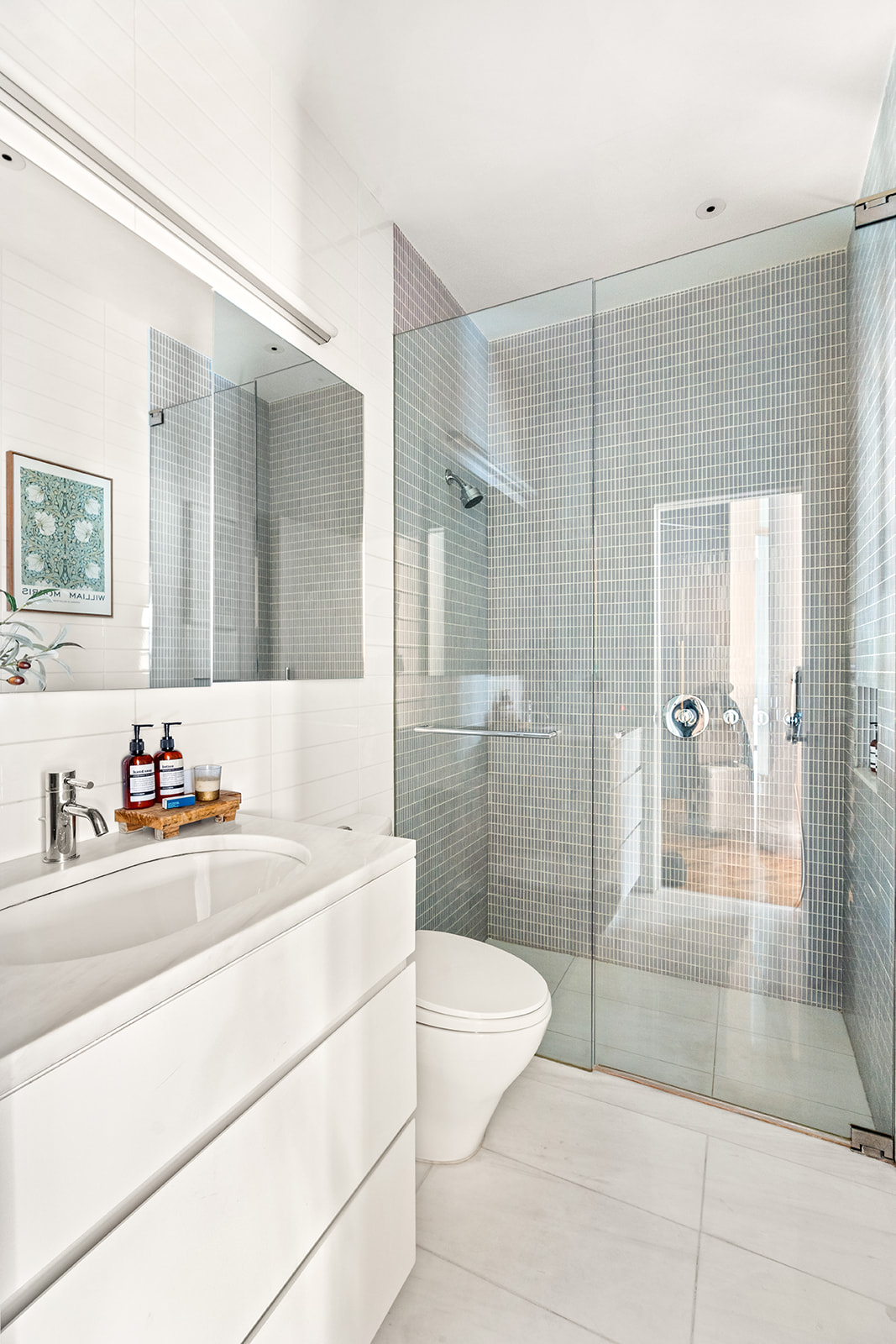 105 5th Avenue, Unit E5 Manhattan, NY 10003 - Photo 9 of 12 a bathroom with a sink a toilet and shower