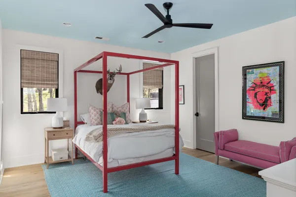 a bedroom with a large bed and a balcony view