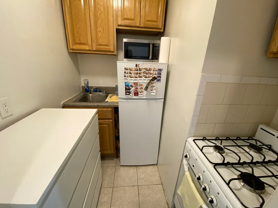 1728 2nd Avenue, Unit 3C Manhattan, NY 10128 - Photo 3 of 4 a kitchen with a stove and a refrigerator