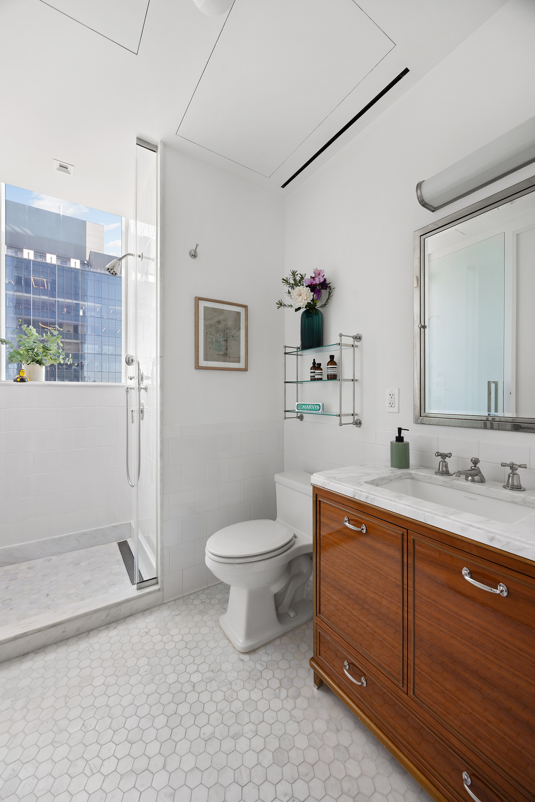 45 East 22nd Street, Unit 32B Manhattan, NY 10010 - Photo 31 of 36 a bathroom with a double vanity sink toilet and shower