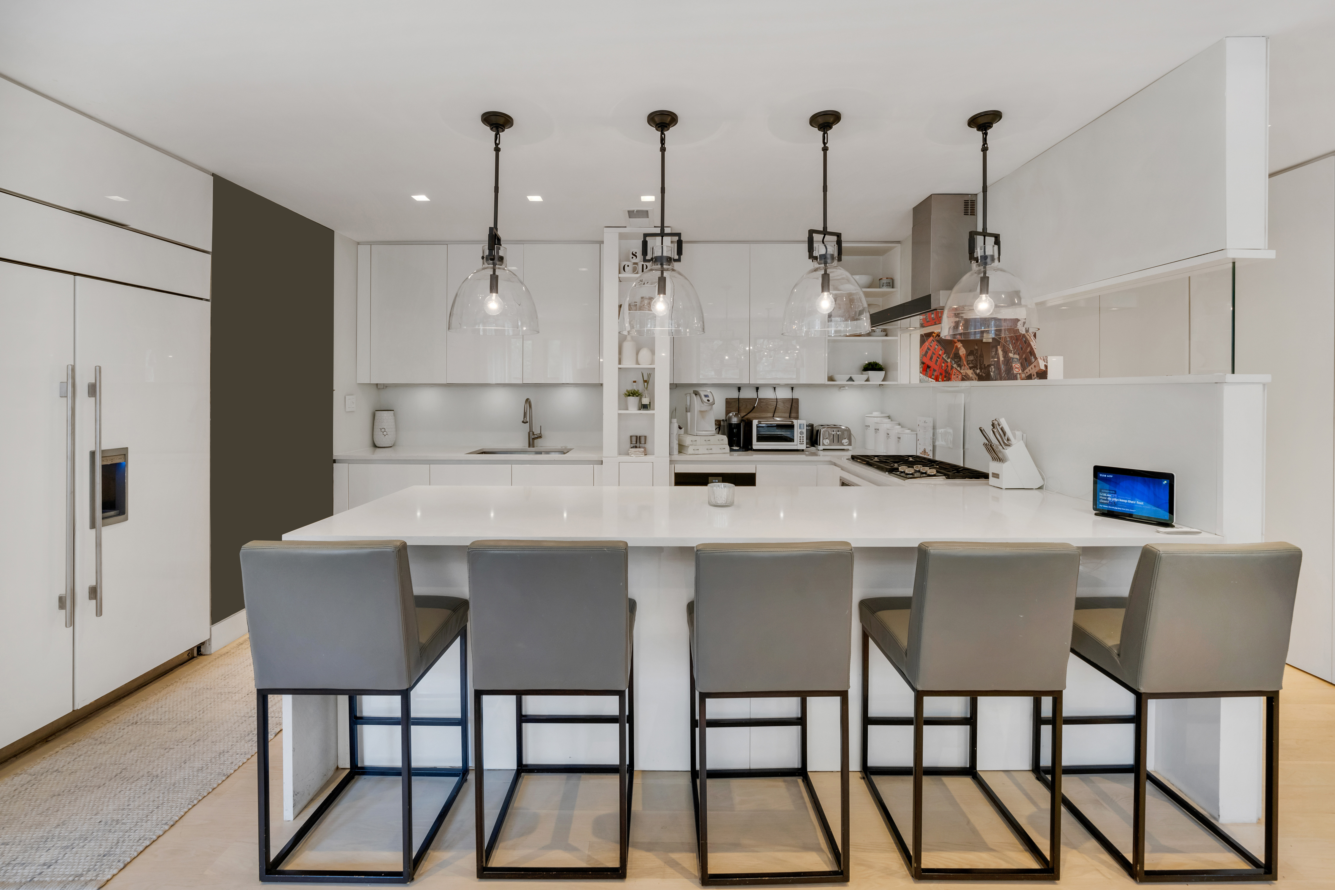 67 Park Avenue, Unit 2BC Manhattan, NY 10016 - Photo 3 of 16 a kitchen with stainless steel appliances kitchen island granite countertop a table and chairs in it