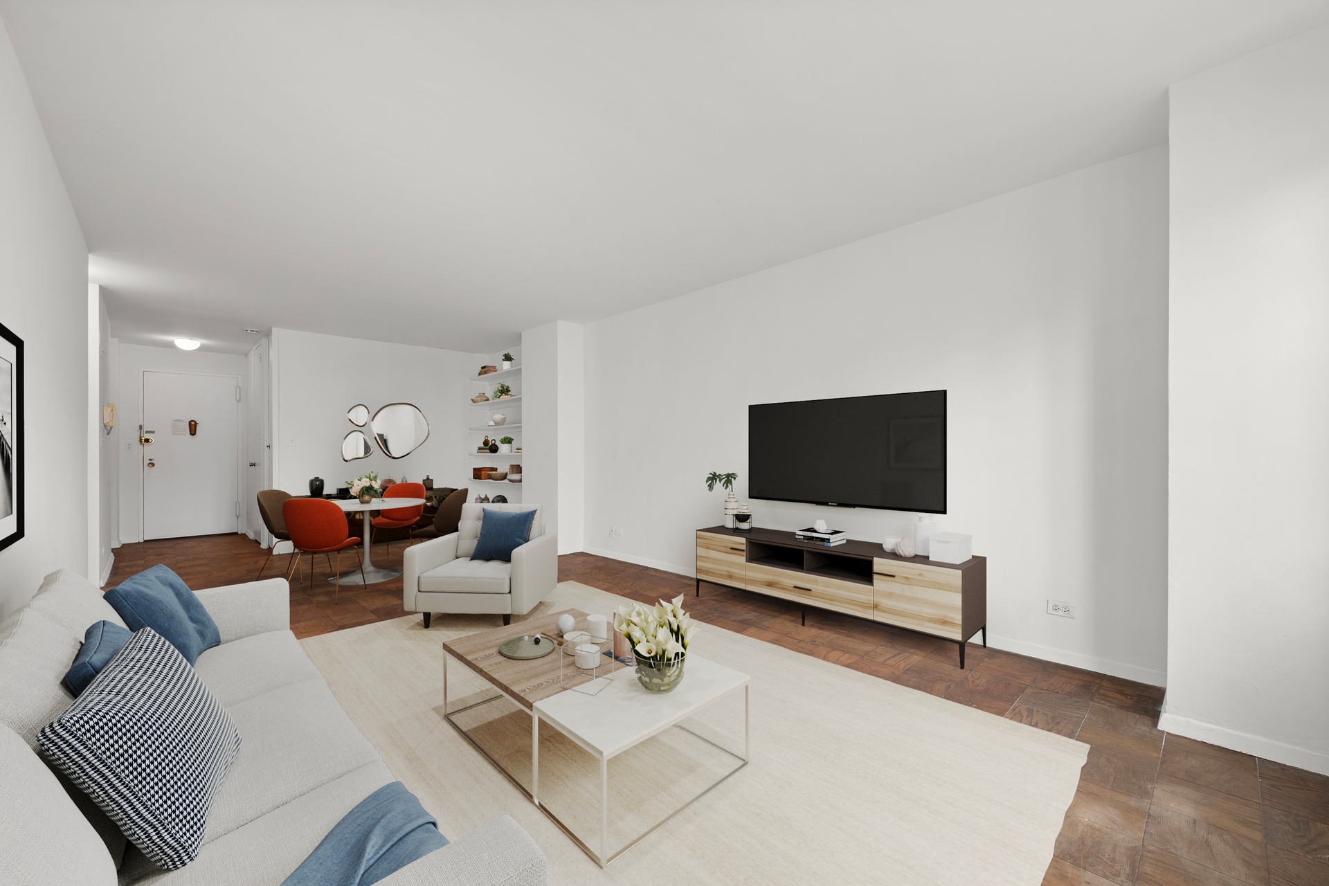 245 East 25th Street, Unit 8K Manhattan, NY 10010 - Photo 3 of 7 a living room with furniture and a flat screen tv