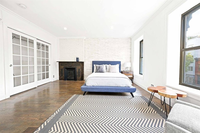 308 Clifton Place Brooklyn, NY 11216 - Photo 18 of 41 a bedroom with a bed and wooden floor