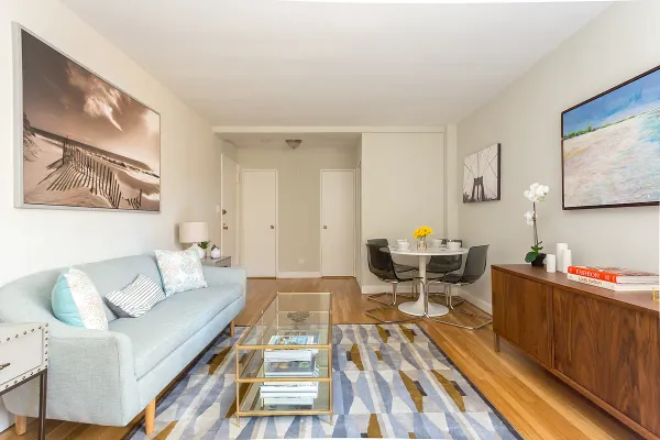 a living room with furniture and wooden floor