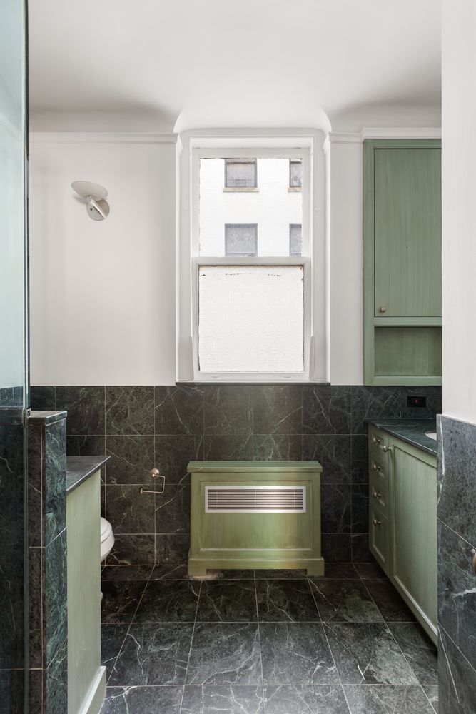 50 Central Park West, Unit 8BB Manhattan, NY 10023 - Photo 16 of 28 a bathroom with a sink a toilet and mirror