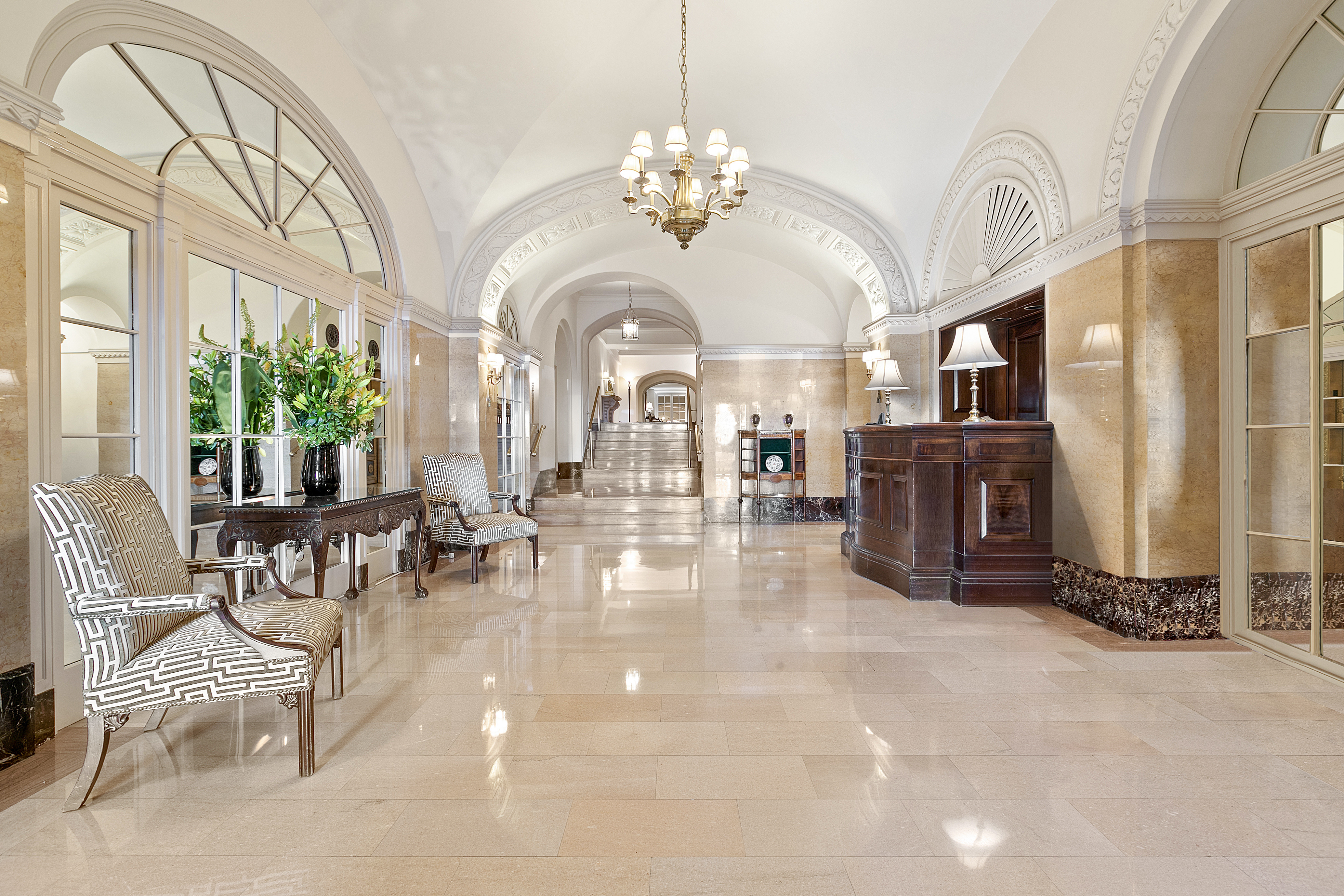 575 Park Avenue, Unit 407 Manhattan, NY 10065 - Photo 10 of 14 a lobby with furniture and a chandelier