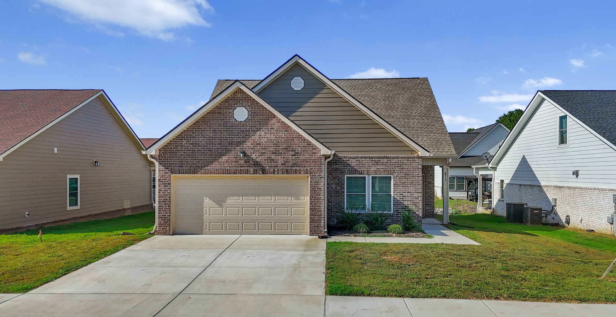 a front view of house with yard and green space