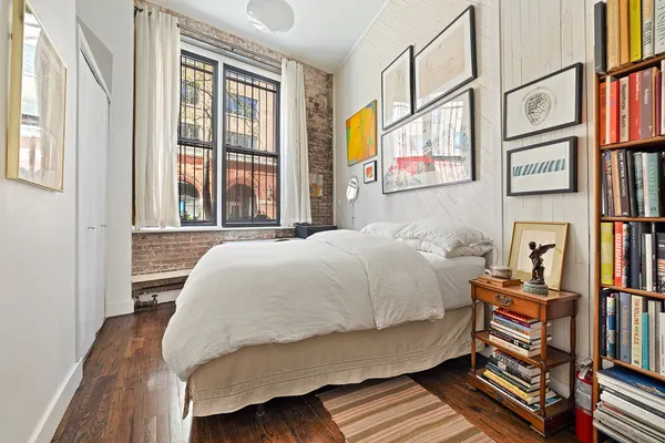 a bedroom with a bed and a window