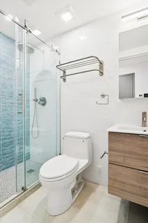 a bathroom with a toilet and a shower