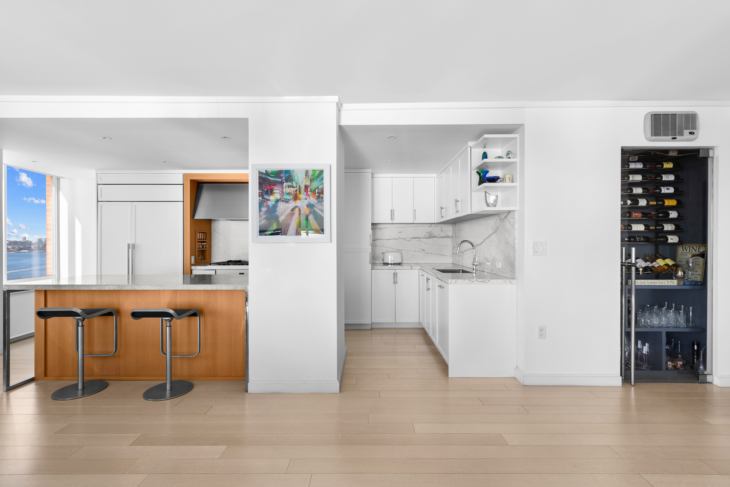 212 Warren Street, Unit 20A Manhattan, NY 10282 - Photo 8 of 23 a view of kitchen with furniture and refrigerator